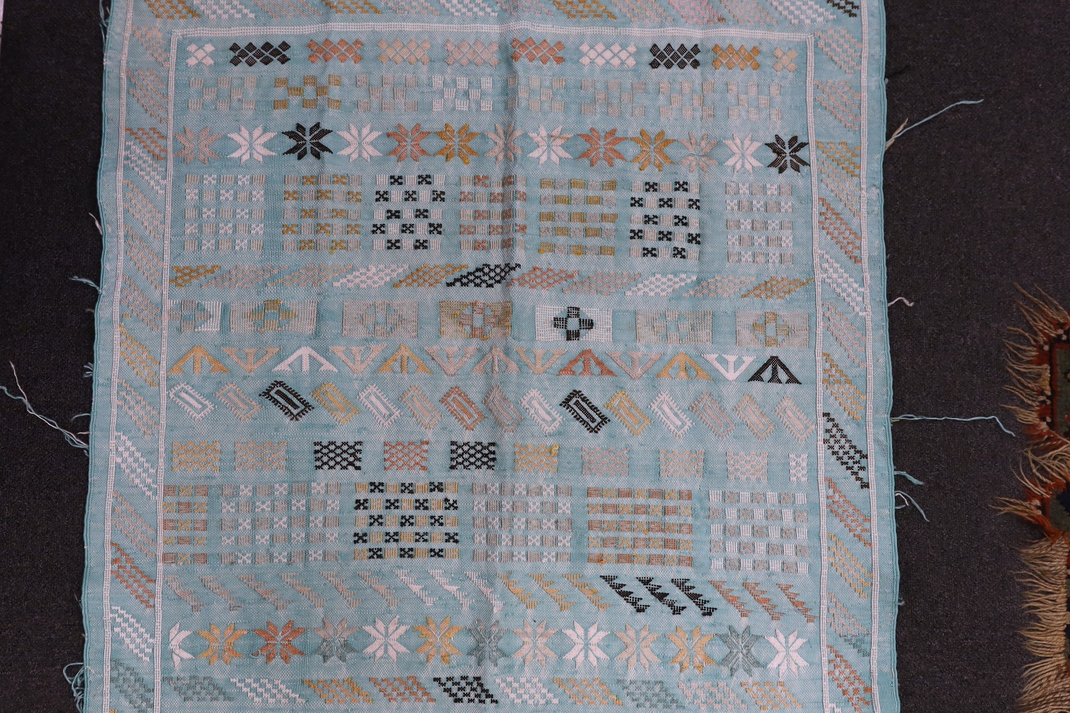 A turquoise rug, possibly Scandinavian